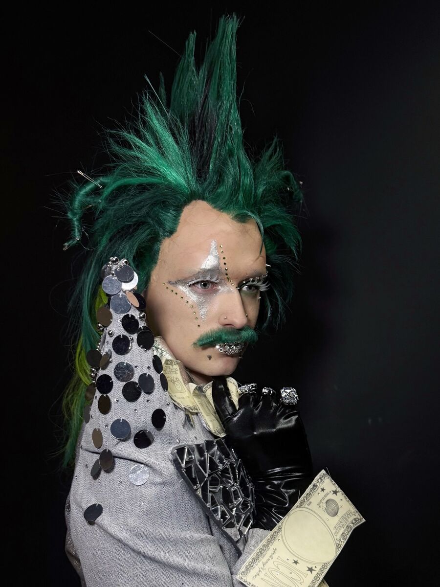 Character costume: green mohawk, silver face work and a coin-sequinned lapel